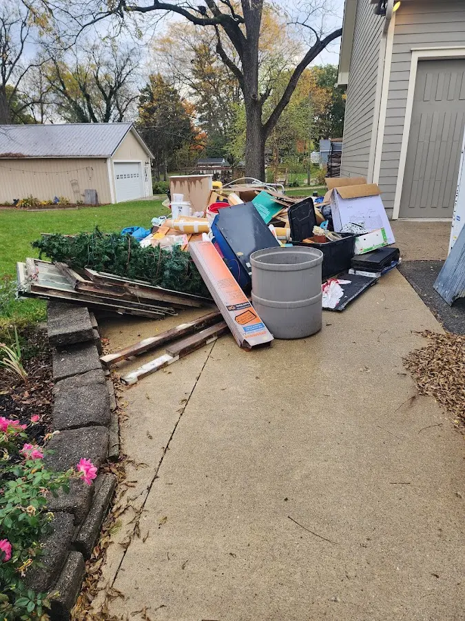 Dumpster being loaded with debris for Estate Cleanout Dumpster Rental in Dahlgren